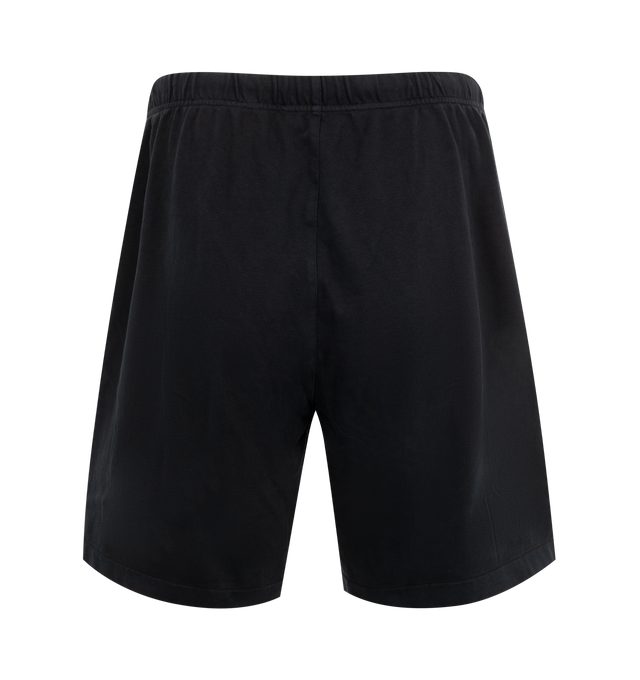 Image 2 of 3 - BLACK - Fear of God Essentials Heavy Jersey Soccer Shorts have an elastic drawstring waist, side pockets, a brand label, and brand screenprinting. 80% cotton, 20% polyester. Made in Vietnam. 