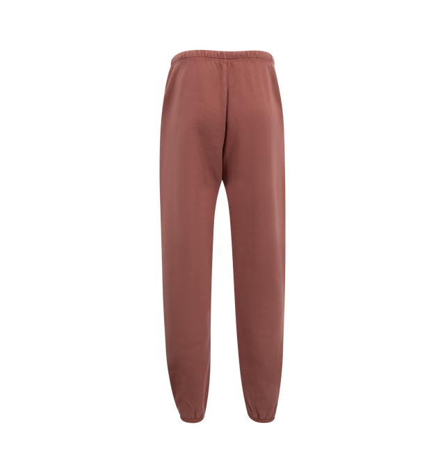 Image 2 of 3 - RED - Fear of God Essentials Elastic Waist Fleece Sweatpants have a drawstring elastic waist, side pockets, a brand label, and elastic at the ankles. 83% cotton, 17% recycled polyester.  