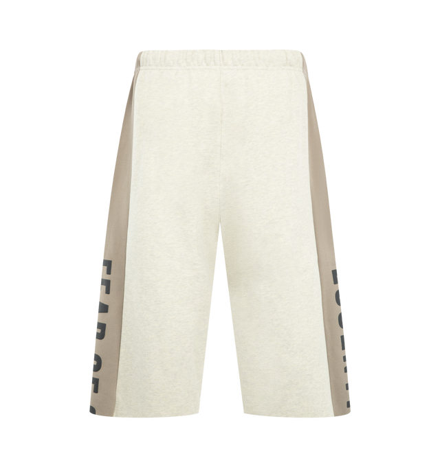 Image 2 of 4 - NEUTRAL - Fear of God Essentials Mens Sweatpants are crafted from heavyweight 380 GSM cotton-blend core fleece. Feature a wide-leg fit, paneled construction, elasticized waistband with bungee drawcord, side-seam pockets, raw-cut hem, puff-printed Fear of God and Essentials branding, and an Essentials logo label. Main Material: 80% Cotton, 20% Polyester.  