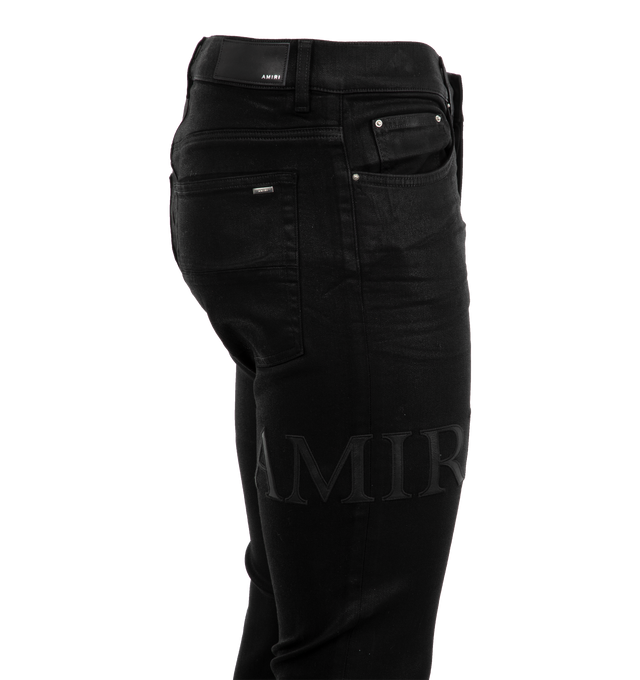 Image 3 of 3 - BLACK - AMIRI Serif Logo Wax Skinny Jean featuring logo on right leg, regular rise, five-pocket style, full length, skinny legs, button zip closure and belt loops. Cotton/polyester/elastane. 