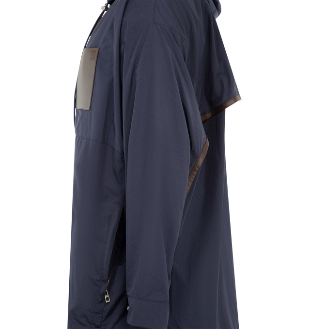 Image 3 of 3 - NAVY - LOEWE PAULA'S IBIZA Hooded Jacket in lightweight technical textured micro ripstop featuring a back vent, relaxed fit, regular length, hooded straight collar with drawstring, leather-trimmed zip front fastening with leather puller, leather-trimmed elasticated drawstring hem, lined hood, seam zipped pockets, leather chest patch pocket, leather-trimmed snap button cuffs and anagram embossed on the chest pocket. Polyamide. Made in Italy. 