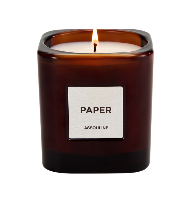 Image 1 of 3 - BROWN - Assouline Library Candle  Paper is a luxury scented candle that evokes the atmosphere of a fantasy library and the pleasure of reading through an elegant fragrance blending cedar, sandalwood, clove, leather, cashmere, bourbon vanilla, and parchment. Housed in a heavyweight amber glass vessel with a textured paper label, this designer candle is crafted from a premium soy, coconut, and paraffin wax blend for a clean, even burn and exceptional scent throw. Top Notes: Clove, Atlas Cedar.  