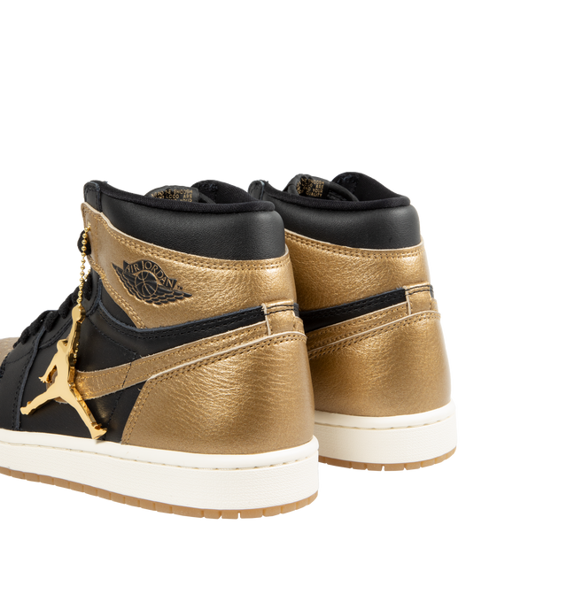 Image 3 of 5 - GOLD - Air Jordan 1 Retro High OG classic sneaker crafted from premium materials. Metallic gold leather upper offers durability and structure. Encapsulated Air-Sole units provide lightweight cushioning. Solid rubber outsoles give you traction on a variety of surfaces. Signature Wings logo stamped on collarStitched-down Swoosh logo. 