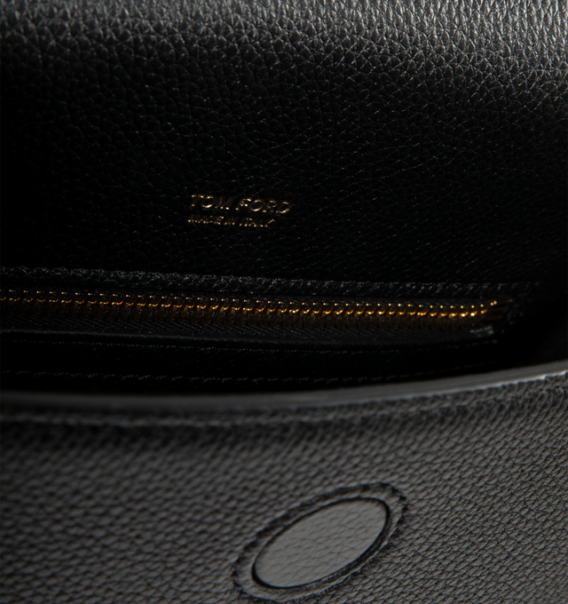 Image 3 of 3 - BLACK - TOM FORD Tara Mini Crossbody Bag in grain leather featuring hanging T closure, adjustable shoulder strap, flap top with magnetic closure, exterior, one slip pocket and interior, one zip pocket. 100% calfskin. Lining: polyurethane. 7.3"H x 7.9"W x 2.8"D. Made in Italy. 