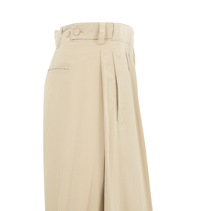 Image 3 of 3 - NEUTRAL - THE ROW Iven Pant featuring tailored low-rise pant in softly crinkled technical silk with barrel leg, front double pleats, adjustable back button tabs and side welt pockets. 65% silk, 35% nylon. Made in Italy. 