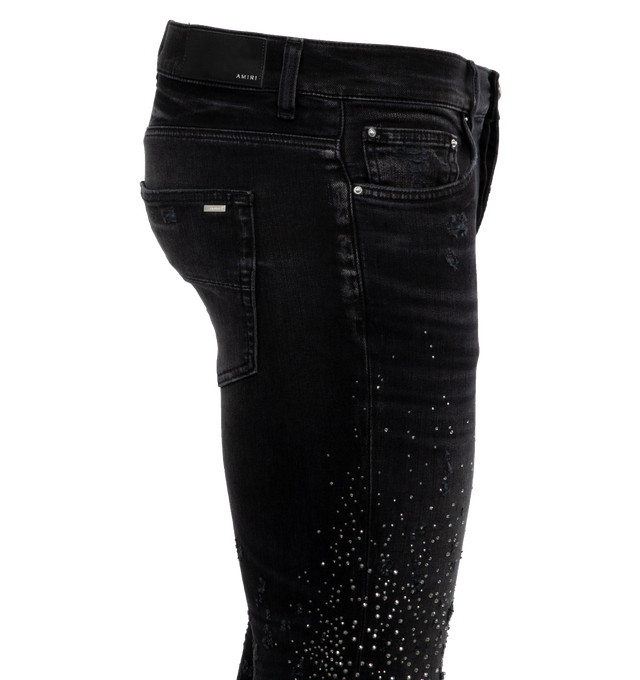 BLACK - AMIRI Crystal Shotgun Jeans featuring belt loops, five-pocket styling, button-fly, leather logo patch at back waistband and logo-engraved silver-tone hardware. 92% cotton, 6% elastomultiester, 2% elastane. Made in USA.