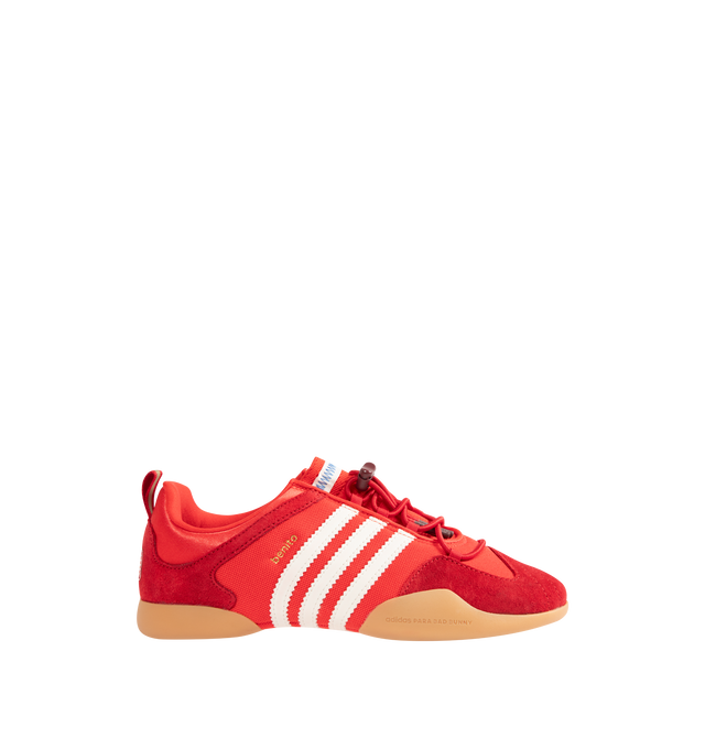 Image 1 of 5 - RED - Adidas Mens Originals x Bad Bunny Ballerina Sneakers are crafted from canvas and suede. Features a low-cut silhouette, lace-up closure with bungee-cord laces, signature 3-Stripes, "Benito" branding, adidas para Bad Bunny detailing, heel pull tab, textile lining, and gum rubber outsole. Upper: Canvas and Suede; Lining: Textile; Outsole: Rubber. Made in Vietnam. 