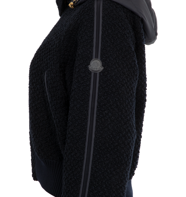 Image 3 of 4 - NAVY - MONCLER Juvigny Hooded Tweed Bomber Jacket featuring piped trims and gold-tone hardware, detachable, adjustable hood, point collar with throat latch, long raglan sleeves with snap cuffs, signature leather logo patch at left sleeve, slip pockets, classic fit, rib-knit hem and two-way zip-front. Virgin wool, polyester, leather. Fill: Down/feather. 