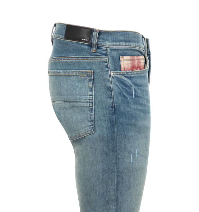 Image 3 of 3 - BLUE - Amiri MA Quad Plaid MX1 Jeans are a 5-pocket style with a button fly, fading, whiskering, flannel underlay patches, contrast stitching, and a logo patch at the back. 92% cotton, 6% elastomultiester, 2% elastane. Made in USA. 