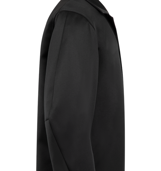 Image 3 of 3 - BLACK - Junya Watanabe Men's Tailored Jacket is crafted from wool serge and features formal tuxedo-inspired construction details, including lustrous satin-faced lapels and covered buttons. A signature patch pocket at the left chest reinterprets Levi's iconic back pocket with arcuate stitching, a red tab, and rivet detailing, blending elements of formalwear and workwear in a distinctly Junya Watanabe Man design. Main Material: 100% Wool. Contrast: 64% Cupro, 36% Silk.  