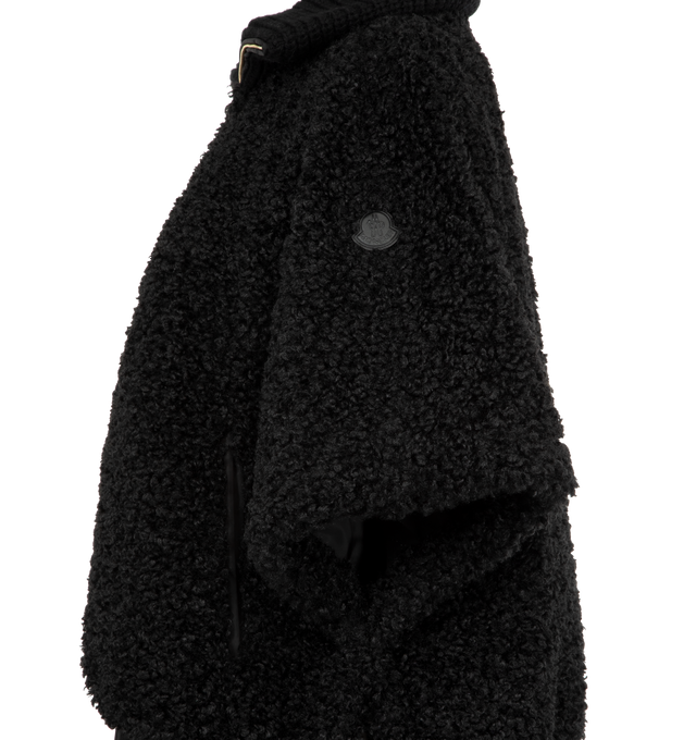 Image 3 of 4 - BLACK - MONCLER Reversible Faux Fur Cape featuring chunky knit collar, two-way zip-front, raglan sleeves, tonal leather logo patch on the left sleeve, relaxed fit, elasticized hem and reverses to a water-resistant recycled polyester. Polyester/leather. Lining: nylon. 