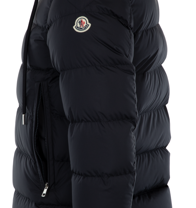 Image 3 of 3 - NAVY - MONCLER Cardere Short Down Jacket featuring recycled polyester lining, down-filled, adjustable hood with logo lettering and zipper closure, zipper closure, zipped pockets and adjustable cuffs. 100% polyester. Padding: 90% down, 10% feather. 