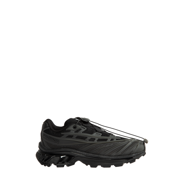 Image 1 of 5 - BLACK - Salomon Unisex XT-EVO Sneakers are built with a synthetic and textile upper and are made to be a performance-driven combining stability and cushioning for lasting comfort. Additional details include Quicklace one-pull lacing, endoFit internal sleeve construction, sensiFIT support, seamless construction, and a lace pocket for streamlined wear. A molded OrthoLite sockliner and Mud ContaGRIP rubber outsole enhance cushioning, durability, and traction across varied terrain. Upper: Synthet 